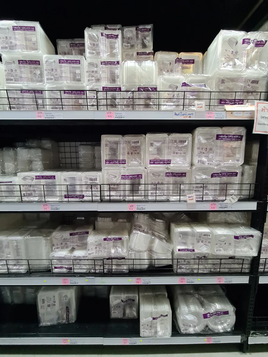 Clear hinged takeaway containers arranged on a store shelf