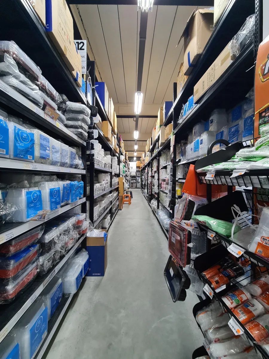 Packaging shelves with paper boxes, trays, and plastic containers