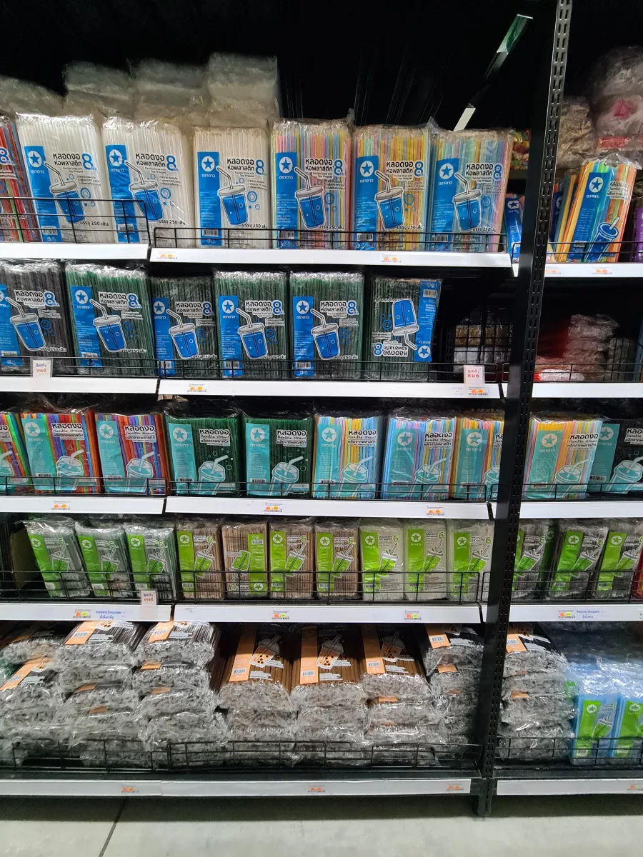 Drinking straws in assorted colors and sizes arranged on shelves